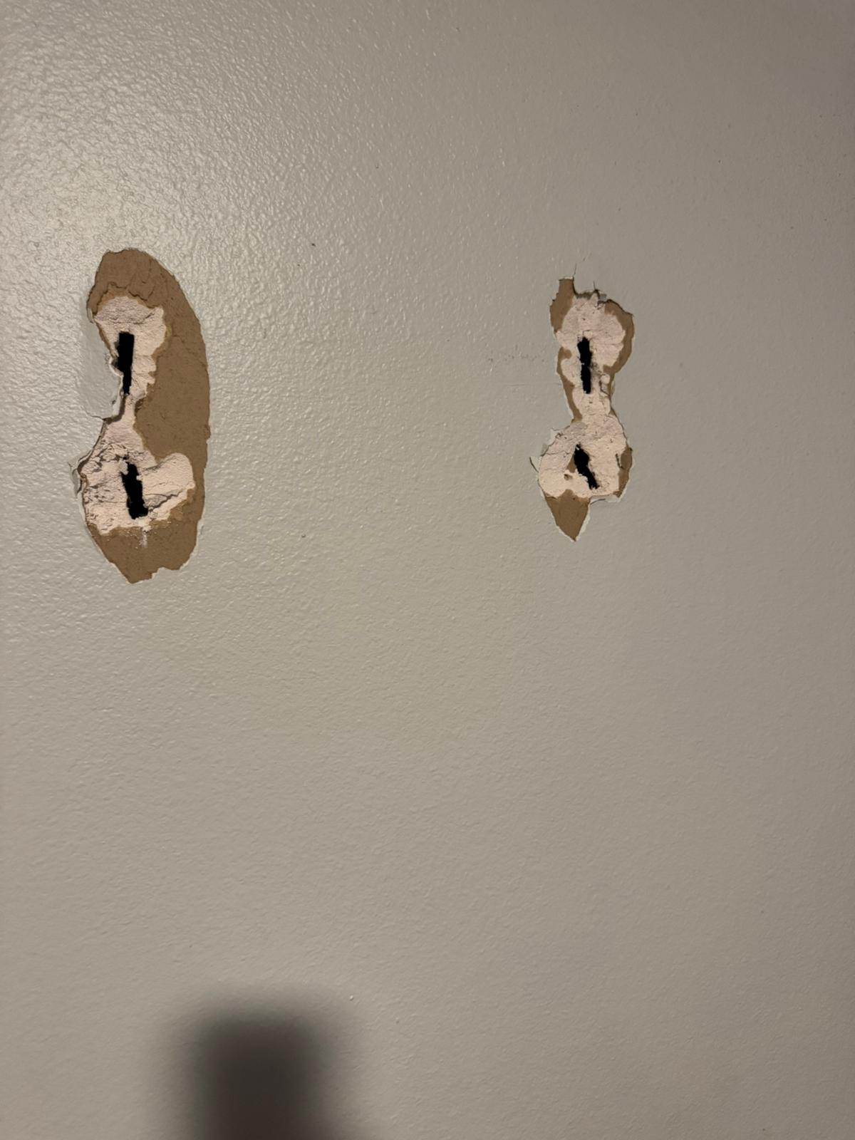 Before — two ragged drywall holes